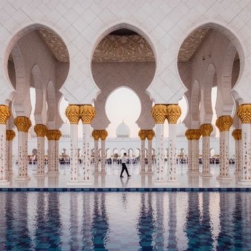 A person standing in front of an indoor pool.