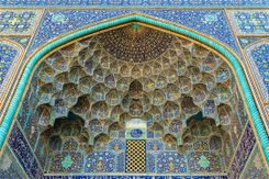 A large blue and green building with a pattern on the ceiling.